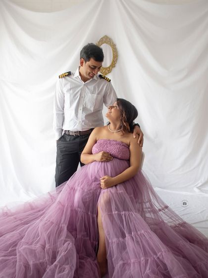 A loving gaze between partners during their purple gown session. The pilot's uniform adds a wonderful personal touch to their story.