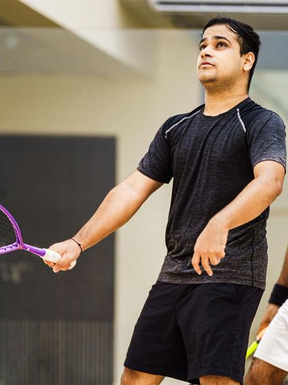 A candid moment between points. Yash Salunkhe looks up, tracking the ball's trajectory. These in-between moments are crucial for telling the complete story of an athlete's performance.