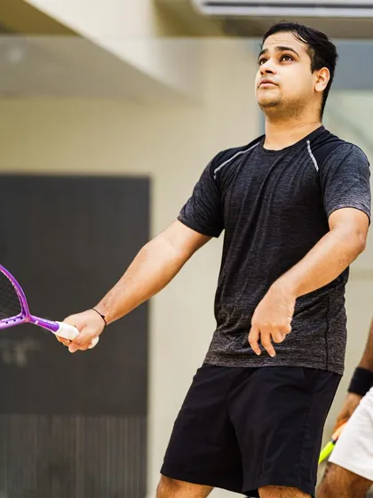 A candid moment between points. Yash Salunkhe looks up, tracking the ball's trajectory. These in-between moments are crucial for telling the complete story of an athlete's performance.