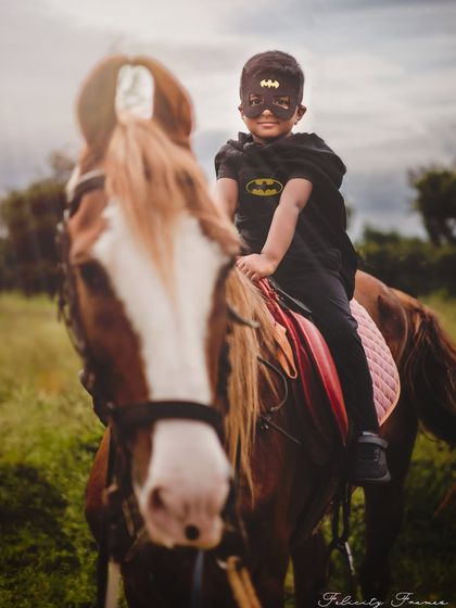 A full-length shot of our little Batman on his horse. Outdoor themed shoots like this are an amazing adventure for older kids.