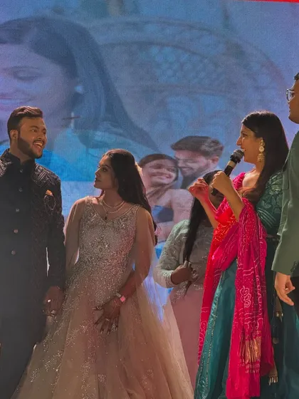 Chatting with the bride and groom on stage. This interaction helps guests feel more connected to the couple and their journey.