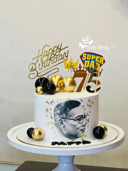 A special cake for a 'Super Dad's' 75th birthday. This design features an edible sketch of his portrait, along with gold and black accents for a distinguished look.