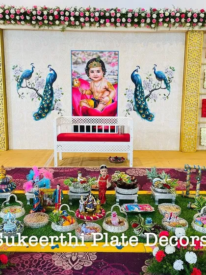 For this baby shower in Annur, the client requested a backdrop with a baby photo and peacock designs. I created a matching platter setup with custom dolls and decorations.
