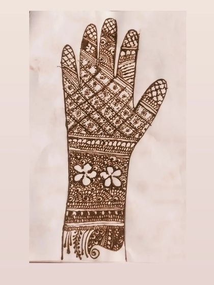 A design sketch for a full-hand mehendi. This shows how I plan out complex patterns, combining a diamond jaal with floral bands and detailed finger work.