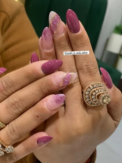 A rich magenta set featuring a mix of solid color and accent nails with a sparkling pink glitter gradient. A perfect choice for a bold and glamorous statement.