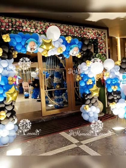 The entrance to Adhiraj's Boss Baby birthday party, featuring a welcoming balloon arch in blue, black, and white, with star and character accents.