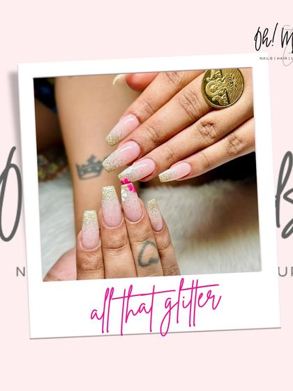Because glitter is always a good idea. This glamorous set features long, coffin-shaped nails with a sparkling gold glitter ombre effect and a delicate pink accent charm.