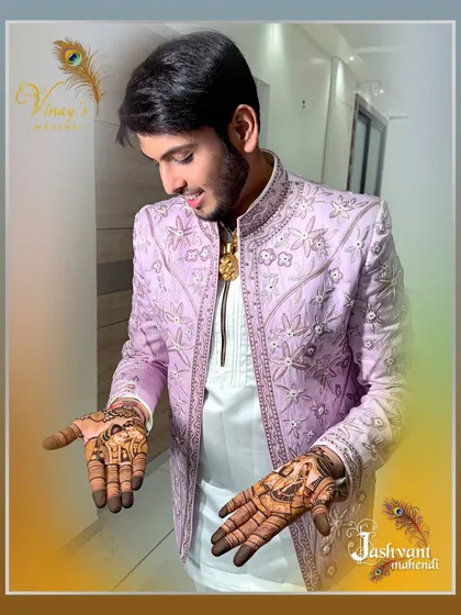 The groom looking down at his hands, a moment of appreciation for the art that will be part of his wedding story.