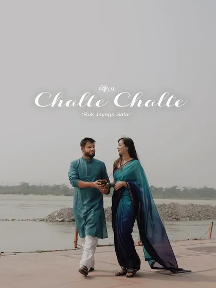 A candid shot of a couple walking by the Ganga, titled 'Chalte Chalte', capturing a classic Bollywood-style romance.
