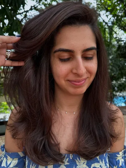 Sometimes all you need is a color refresh and a good haircut. I touched up her roots, toned her existing highlights, and gave her a fresh layered cut to bring her hair back to life.