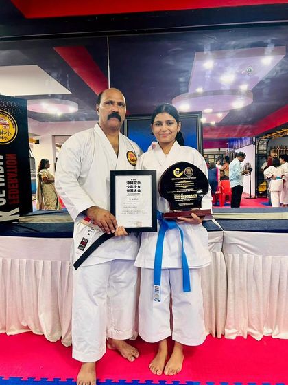 A student holding her certificate and trophy after competing in Okinawa. This opportunity to represent our dojo in Japan is a life changing experience that we are proud to offer.