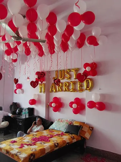 This photo shows a 'Just Married' setup in progress. It gives an idea of how a regular room can be transformed for a wedding night surprise.