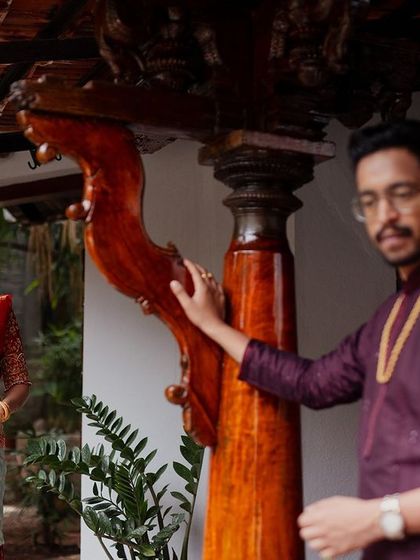 A couple shares a look, framed by the unique wooden pillars of our architecture.
