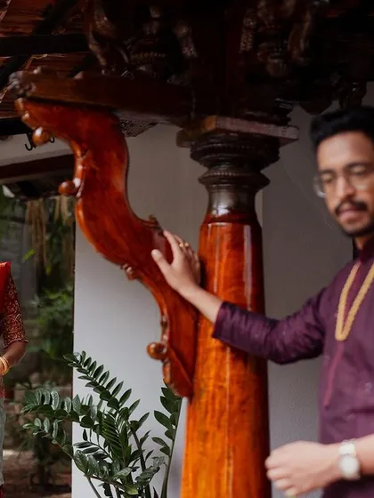 A couple shares a look, framed by the unique wooden pillars of our architecture.