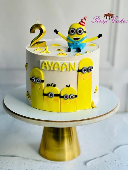 A fun Minions cake for Ayaan's second birthday. The cake is decorated with several of the mischievous yellow characters and topped with one ready to party.