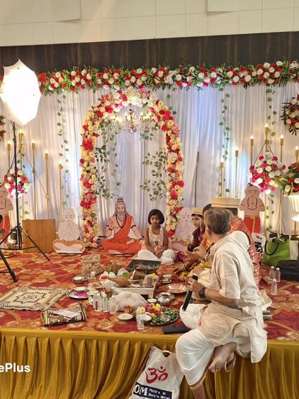 A religious ceremony (puja) taking place on a stage I decorated. The setup is both beautiful for the event and functional for the rituals.