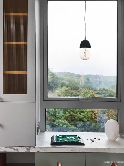 The study desk in the kids' room is positioned by the window to offer a view of the greenery outside, creating an inspiring spot for homework and creativity.