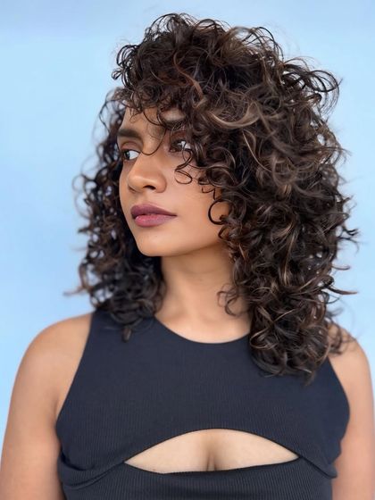 Another view of these stunning espresso curls, showing the volume and shape created by our expert cutting technique.