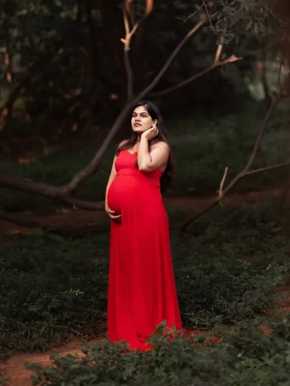 A full-body shot of the Rosie gown. Made of georgette and lycra, it features a sweetheart neckline and a versatile skirt that can be worn to show or hide the bump.