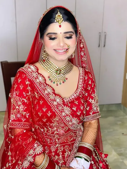 A happy bride is the most beautiful bride. Her smile says it all, with a makeup look that features soft golden eyes and a radiant complexion, perfect for her wedding day.