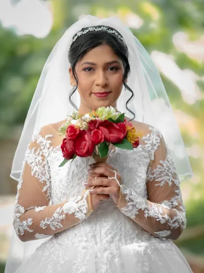 A classic bridal portrait. The bride looks directly at the camera, creating a personal and engaging image that highlights her beauty and confidence.