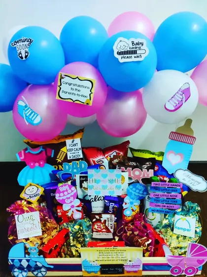 A huge congratulations hamper for the parents-to-be. It's overflowing with chocolates and snacks, and decorated with fun 'Baby loading' and 'I can't keep calm I'm going to be a dad' signs.