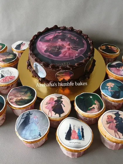 A cake and matching cupcakes based on the Broadway show "Wicked the Musical," with edible images from the play.