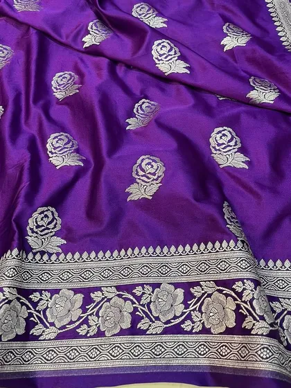 A detailed view of the purple Mashru silk saree's border and motifs.