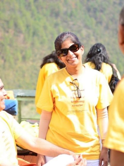A smiling student during a break. The happiness that comes from deep practice and good company is evident.