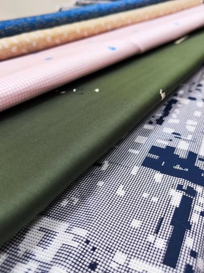 A selection of fine fabrics for summer shirts and kurtas, featuring prints and solid colors.