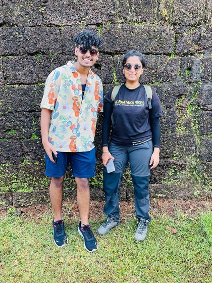 Two of our trek leads posing against the ancient walls of Mirjan Fort, a stop on our Gokarna trip.