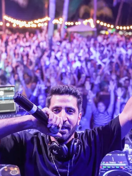 On the mic, in the moment, with the incredible crowd in Mauritius. Hyping the audience and connecting directly with them is a huge part of my live DJ sets. It's all about creating that shared, electric atmosphere.