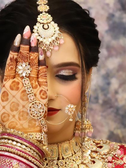 A creative shot showing off the beautiful eye makeup, the intricate henna, and the stunning hand jewellery.