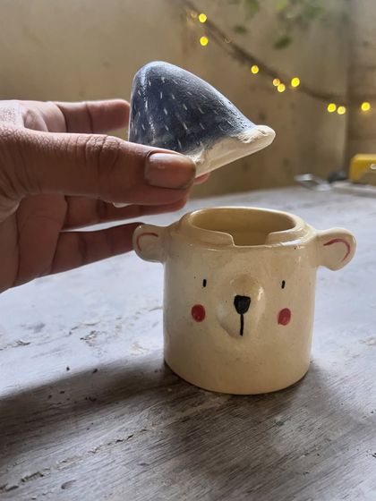 This sweet little teddy bear jar was made by Tanyaa. The lid is the bear's head, and the jar is its body. It’s a wonderfully playful and functional piece.
