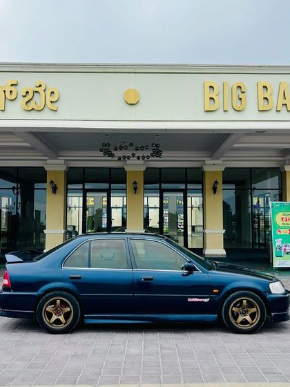 A classic sedan parked in front of our main entrance, ready for a weekend getaway. We're the perfect pitstop to relax and recharge.