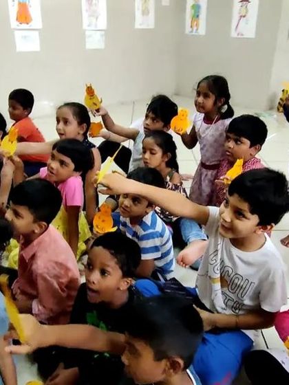 A classroom full of children engaged in a puppet-making activity. This kind of focused, hands-on work is a fantastic way for kids to develop creativity and fine motor skills.
