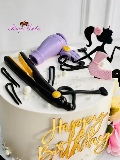 A close-up view of the detailed, handcrafted fondant salon tools on the hairstylist-themed cake. Every piece is made to be completely edible.