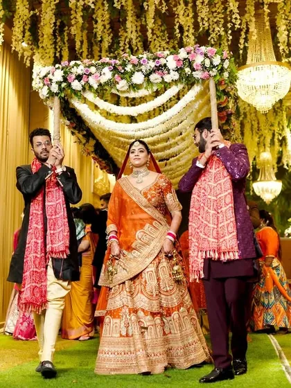 The bride's entry under a beautiful floral 'phoolon ki chadar'.
