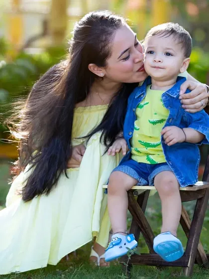 A sweet kiss for her son, a perfect candid moment.