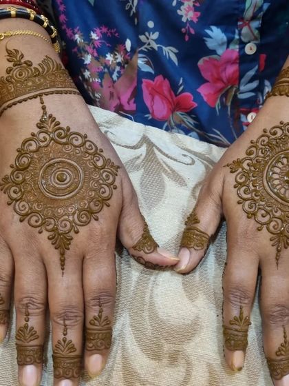 A beautiful pair of hands with matching mandala designs. This is a great option for friends or sisters who want to get similar henna at a party.