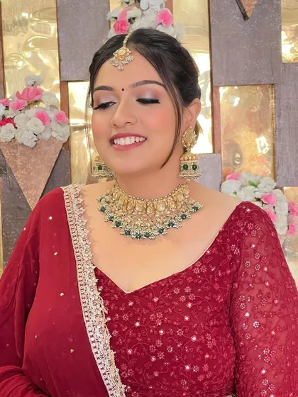 A classic red lehenga look with minimal makeup and a timeless bun.
