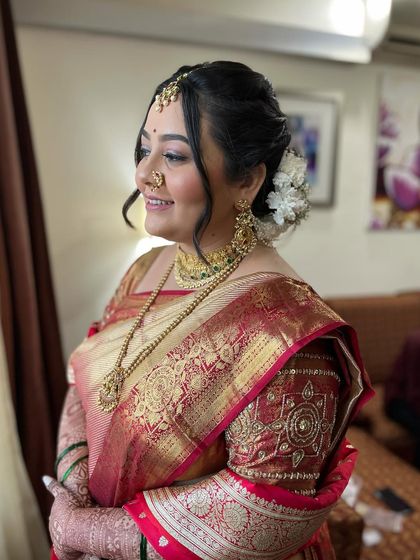 A side profile of the bride, showing the elegant hairstyle and flawless makeup. The look is timeless and sophisticated.