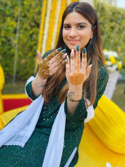 Another pose from the same client, giving a clearer view of her two different minimalist designs. One is a heart motif, and the other is a small mandala.