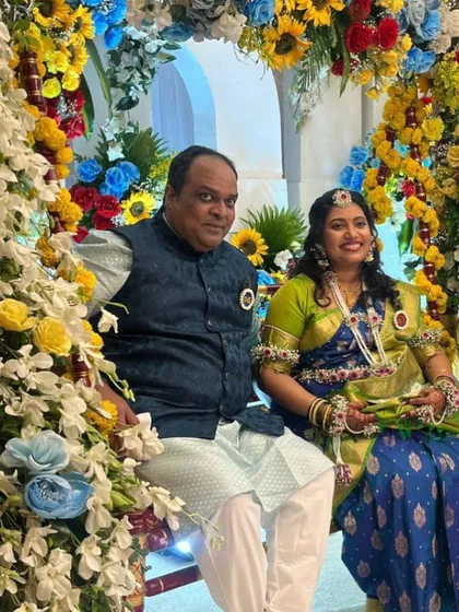 This mom-to-be chose a vibrant floral set with pops of orange and green to match her beautiful blue and green saree for her baby shower celebration.