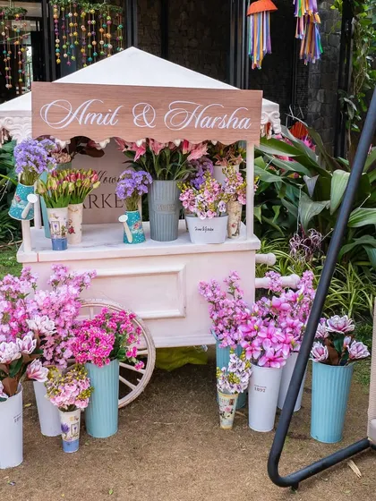A charming, custom-branded flower cart, adding a touch of rustic elegance and an interactive element to the wedding festivities.