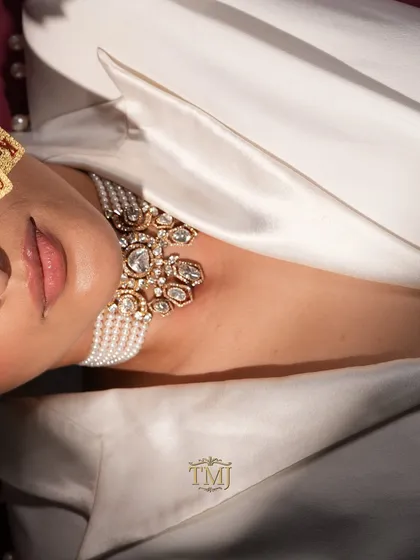 A creative, tilted shot of the Polki and pearl choker, emphasizing its luxurious feel and intricate design.
