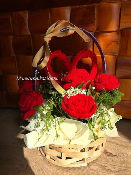 A romantic basket arrangement of handmade red crochet roses and heart-shaped accents. This is a perfect gift for Valentine's Day, anniversaries, or just to say "I love you."