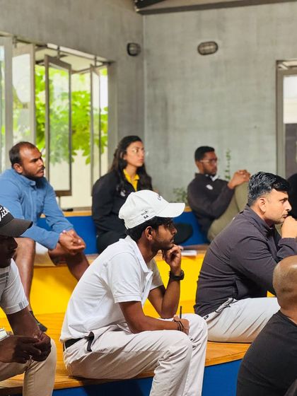 My coaches listening intently during a strength and conditioning presentation. Cross-departmental education ensures a truly holistic approach to athlete development.