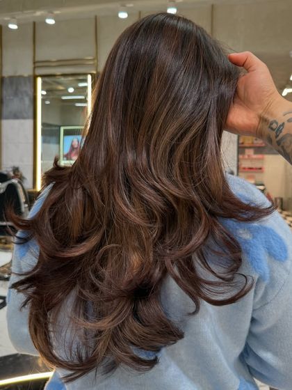 The full look of this mocha brown color, styled with layers and soft waves. It's a classic, sophisticated look that is always in style.