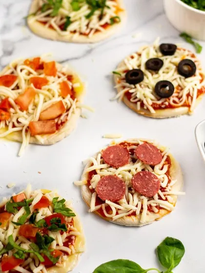 For cocktail parties or as appetizers, I offer these mini pizzas with a variety of toppings like pepperoni, black olives, and fresh vegetables. They are easy for guests to enjoy while mingling.